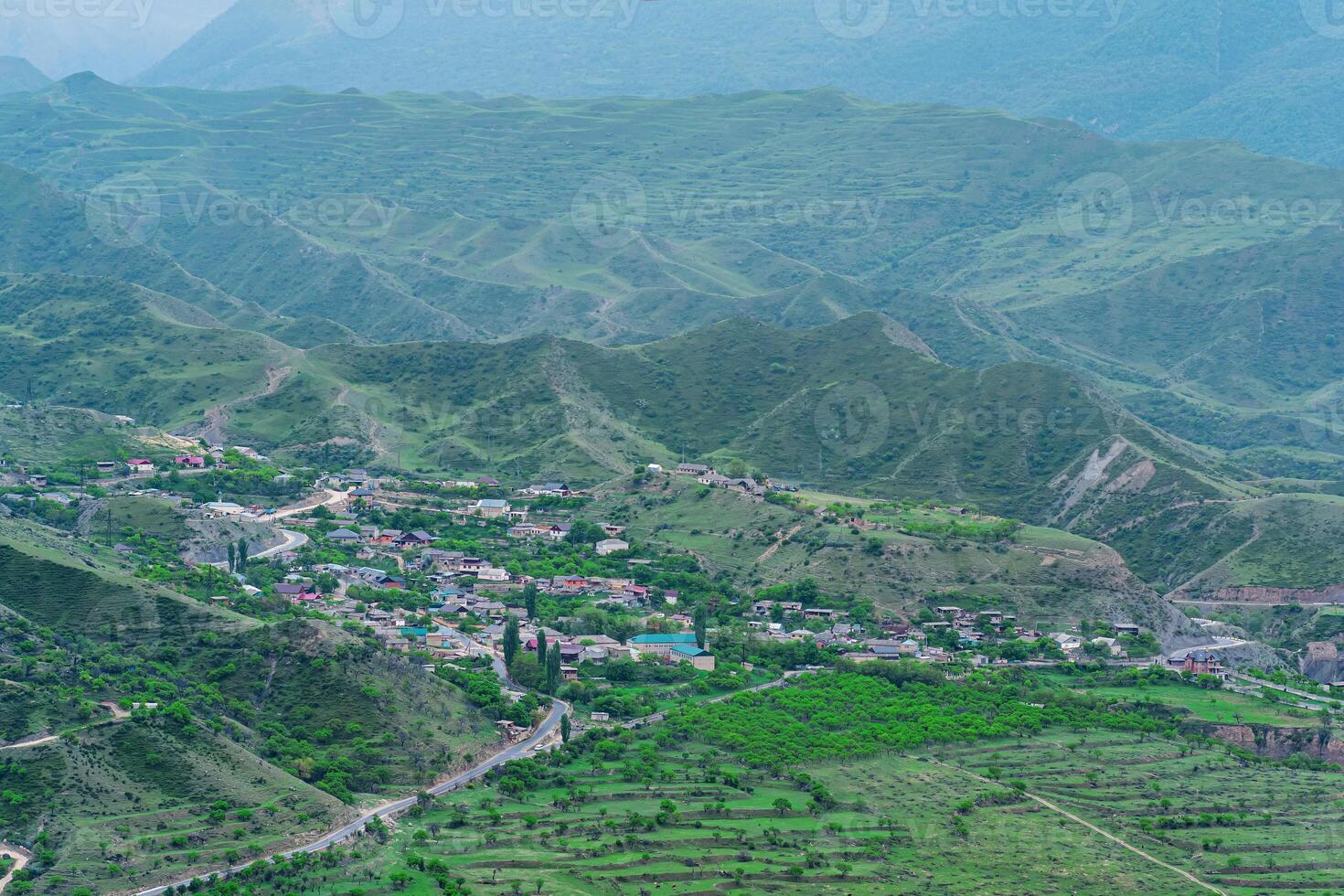 aerial view of a village in a mountain valley among gardens and fields in Dagestan photo