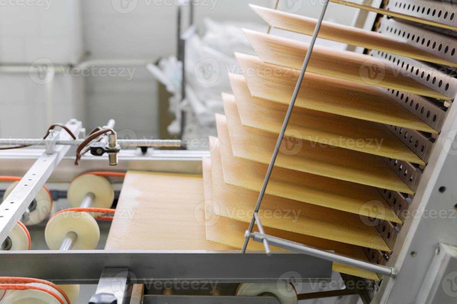 freshly baked wafer sheets move along the conveyor of a confectionery factory photo