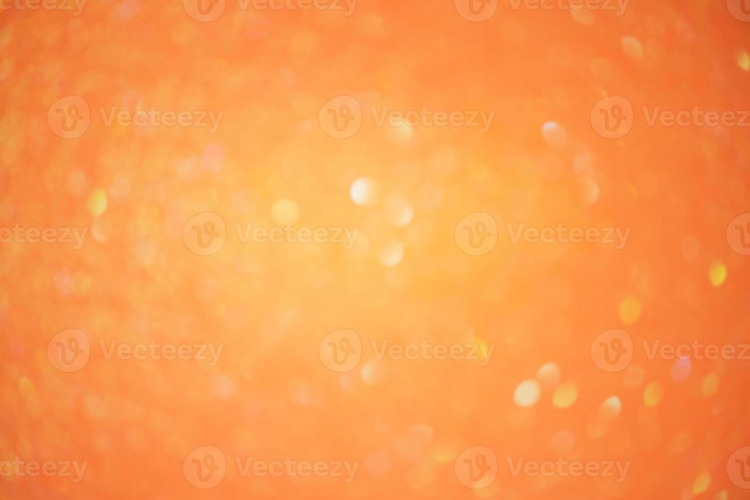 Sparkles defocus light. Glitter paper defocus as background. Orange background light and shadow. photo