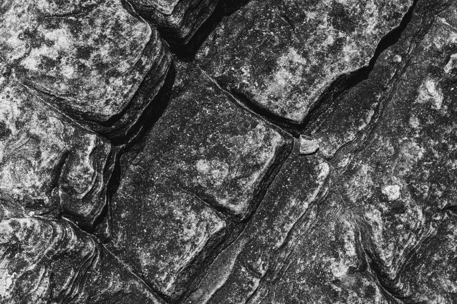 Rock texture in top view serves as a unique and captivating.  Nature from top of hill. Black and white shot. photo
