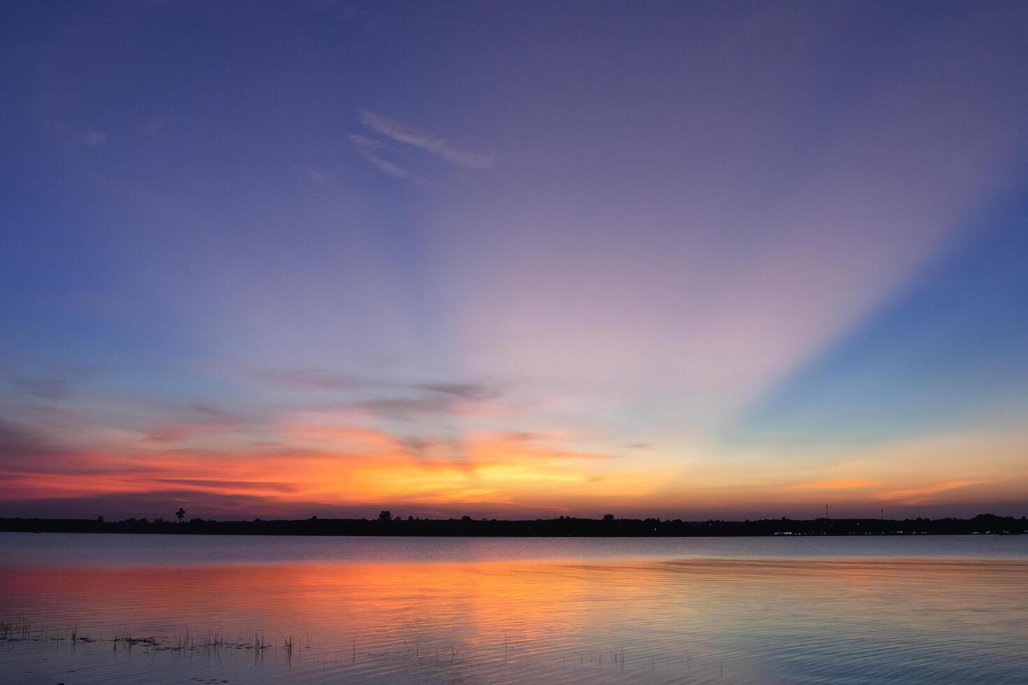 Experience the mesmerizing beauty of a landscape featuring clouds floating over a serene sea during twilight. photo