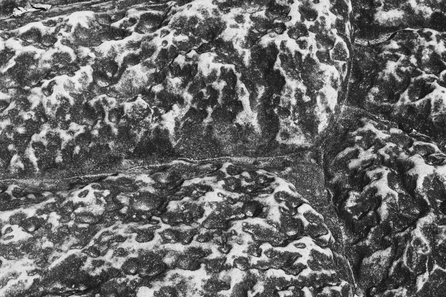 Rock texture in top view serves as a unique and captivating.  Nature from top of hill. Black and white shot. photo
