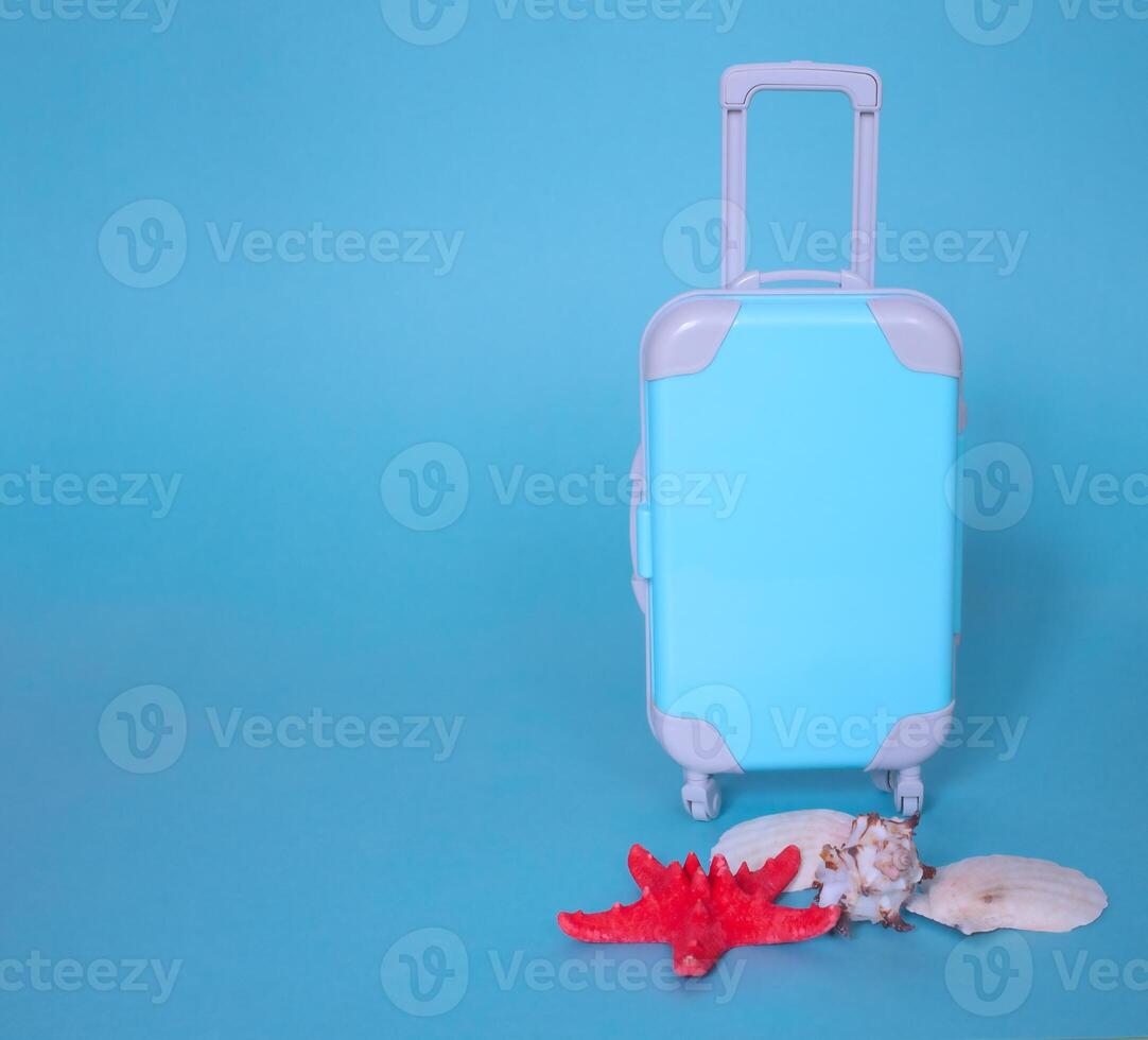 Fully opened blue suitcase, on a blue background, top view. Vacation, travel concept. copy space photo