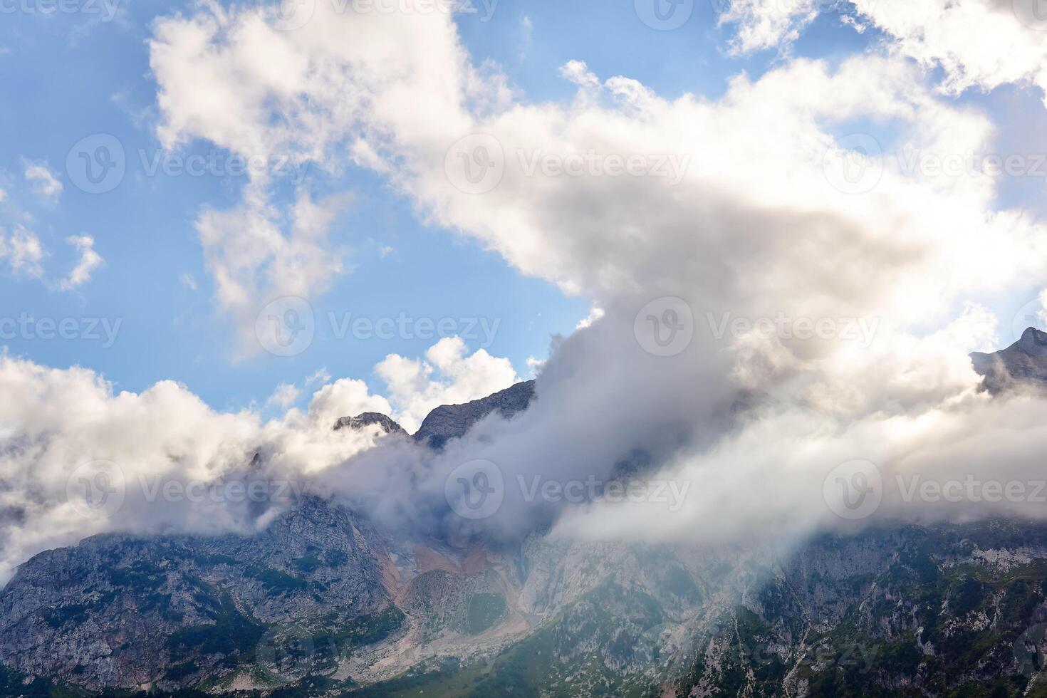 mountain landscape with a sunbeam breaking through the clouds photo