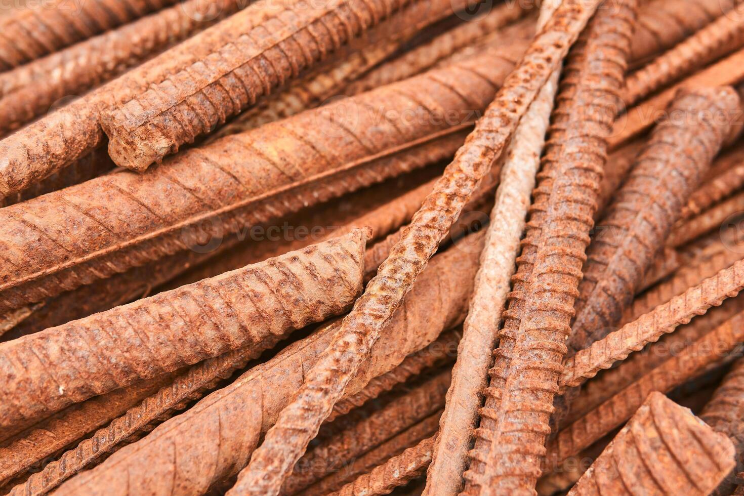 rusty reinforcing bars piled in a heap close-up photo