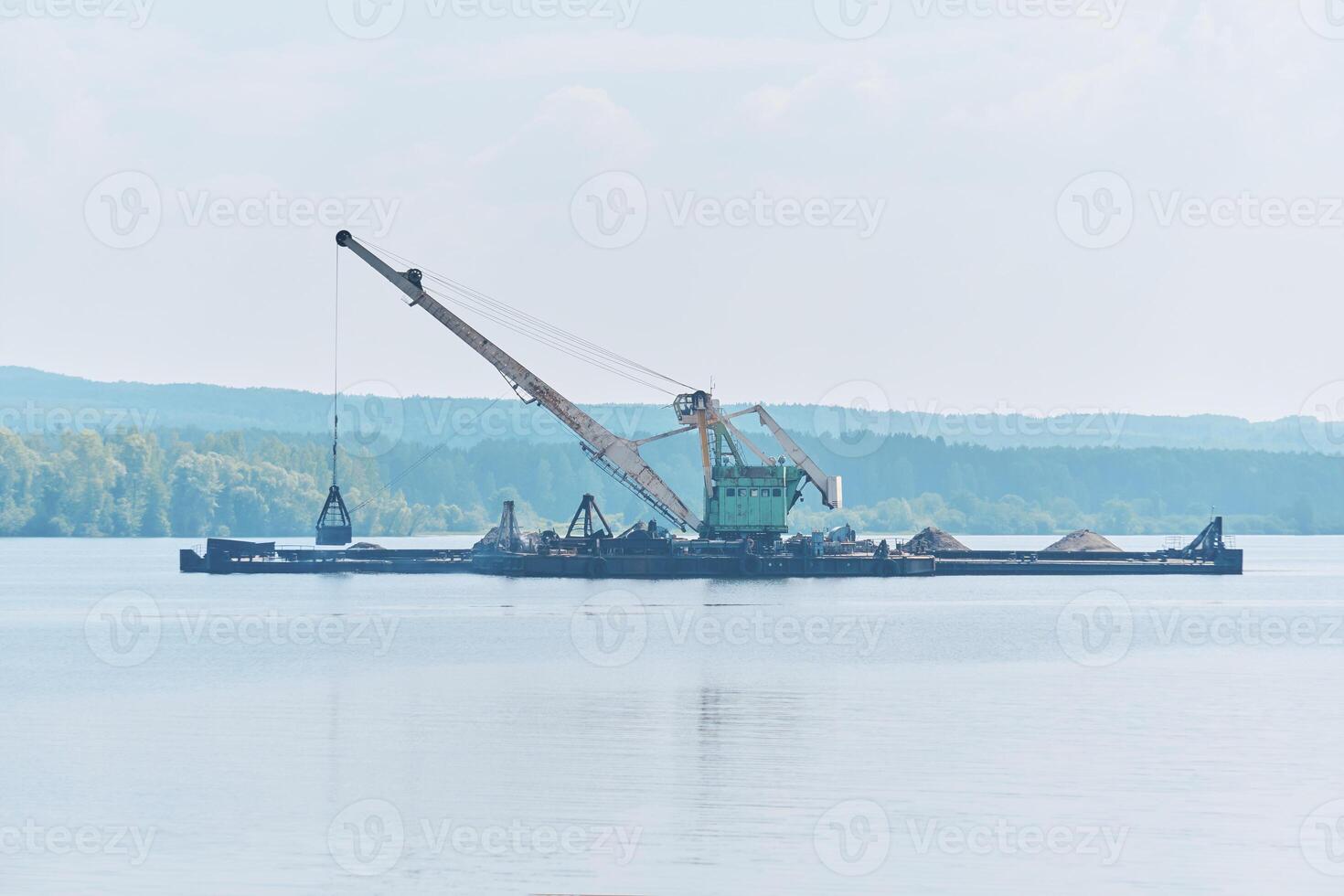 dredging boat is working to deepen the fairway on the river photo