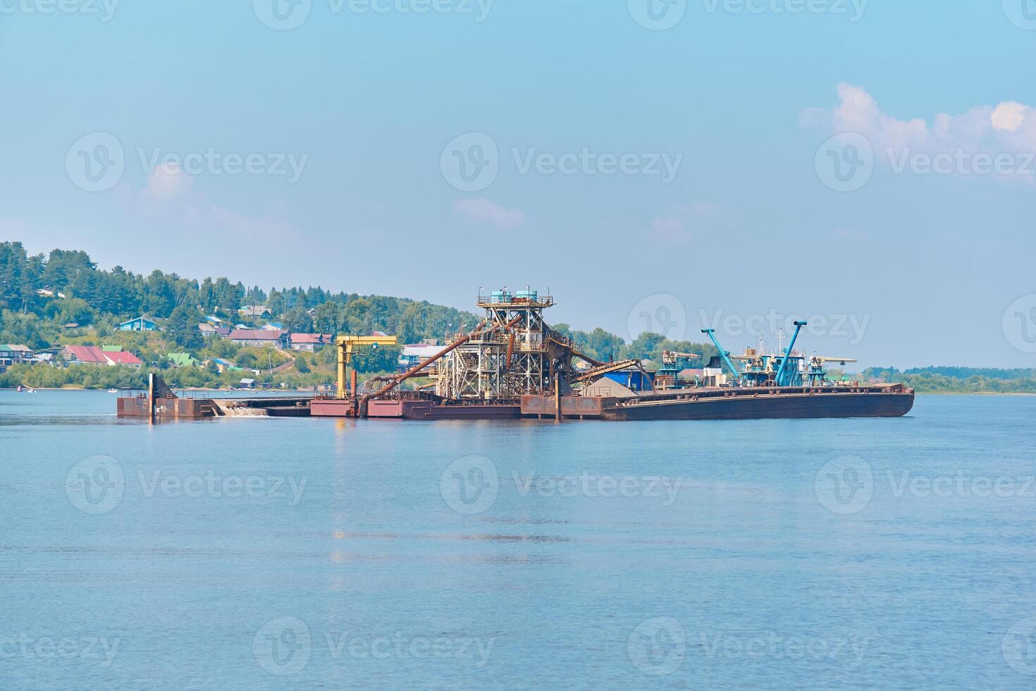 floating sand mining plant - dredger and separator - on the river photo