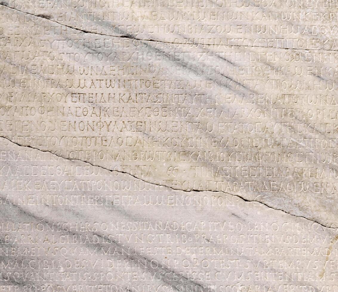 fragment of a marble slab with a carved text on the collection of taxes in ancient Greek from Chersonesos, Crimea photo