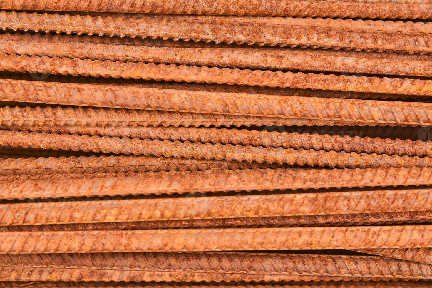 background - pieces of rusty rebar piled in a heap close-up photo