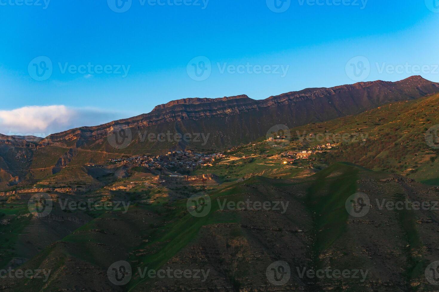 mountain landscape with a village on a slope under a huge rocky ridge, Chokh in Dagestan photo