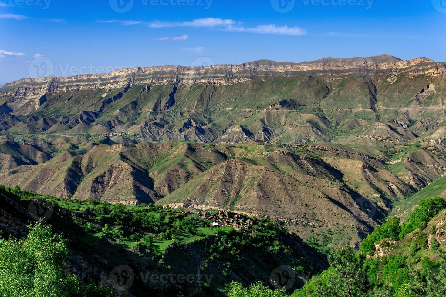 mountain landscape, a huge canyon with an abandoned farm on one of the ledges photo