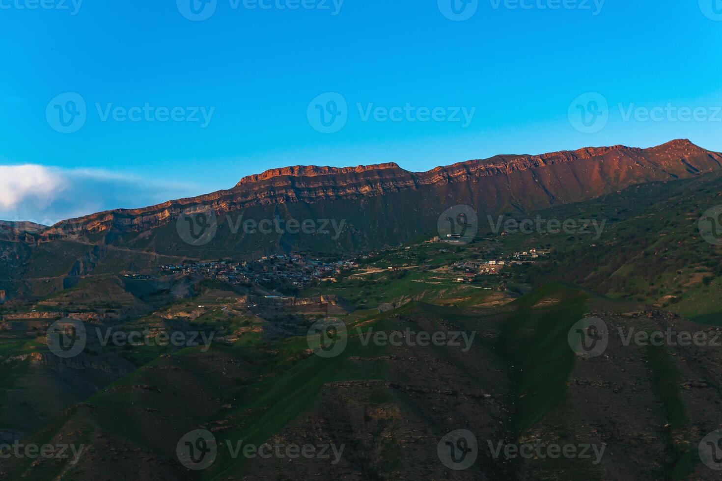 mountain landscape with a village on a slope under a huge rocky ridge, Chokh in Dagestan photo