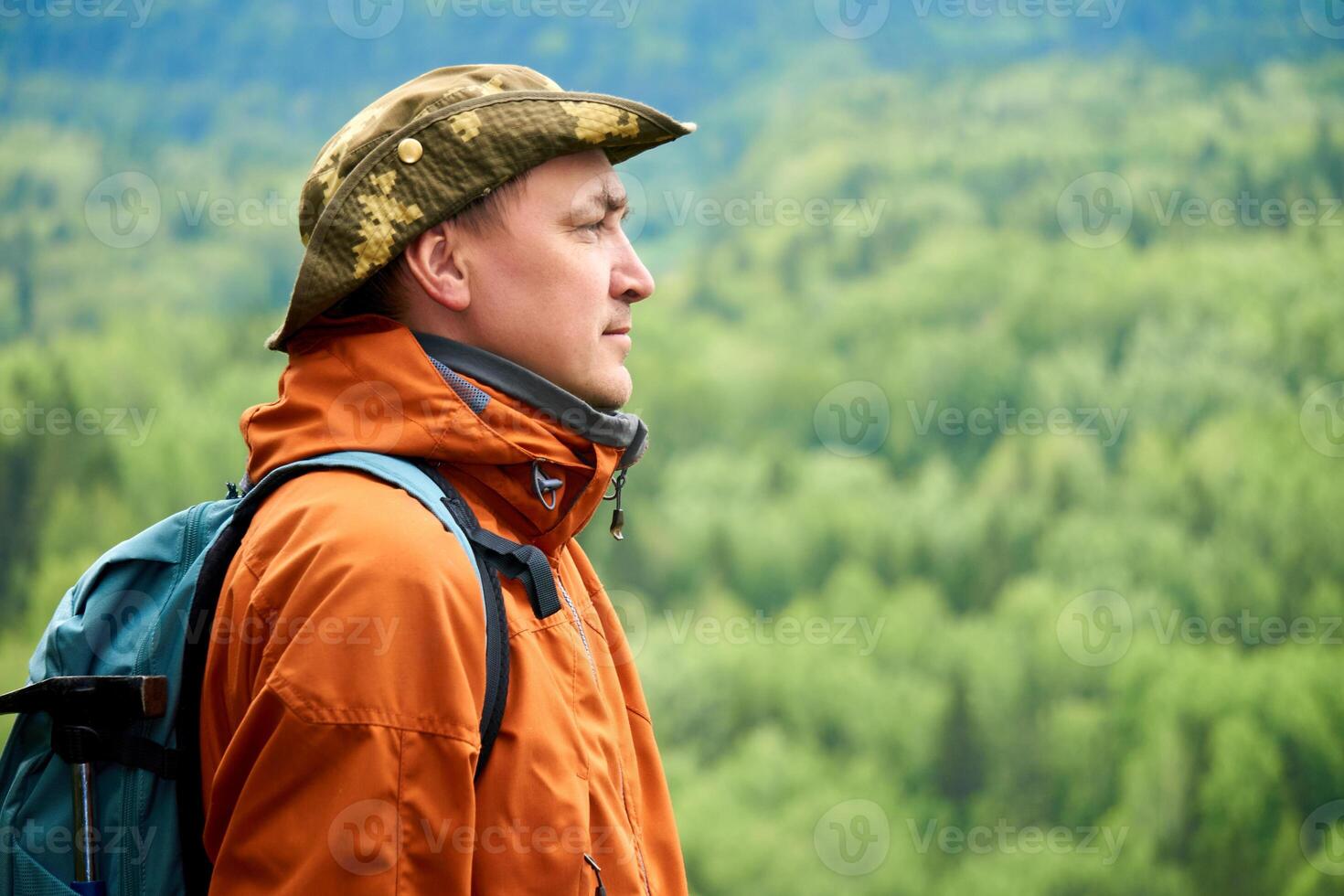 traveler naturalist against the backdrop of a wooded mountain landscape photo