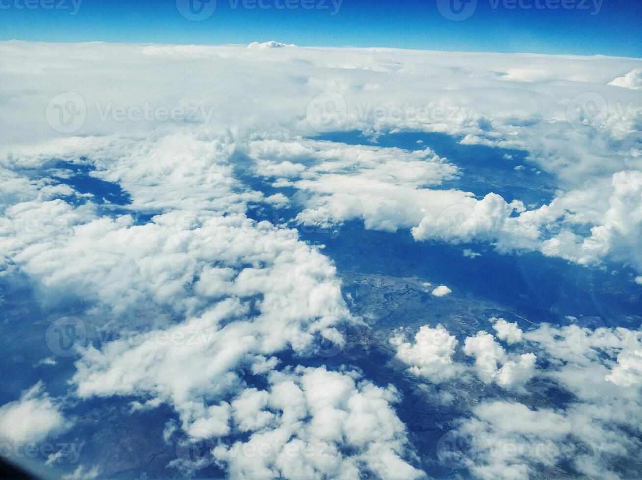 Contrast photo of clouds behind the plane porthole