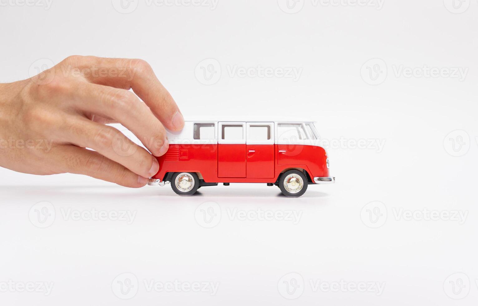 Hand holding a toy car isolated on white background. After some edits. photo