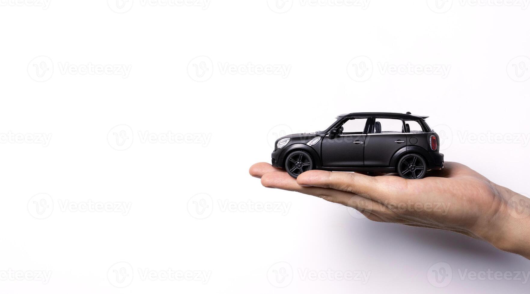 Hand holding a toy car isolated on white background. After some edits. photo