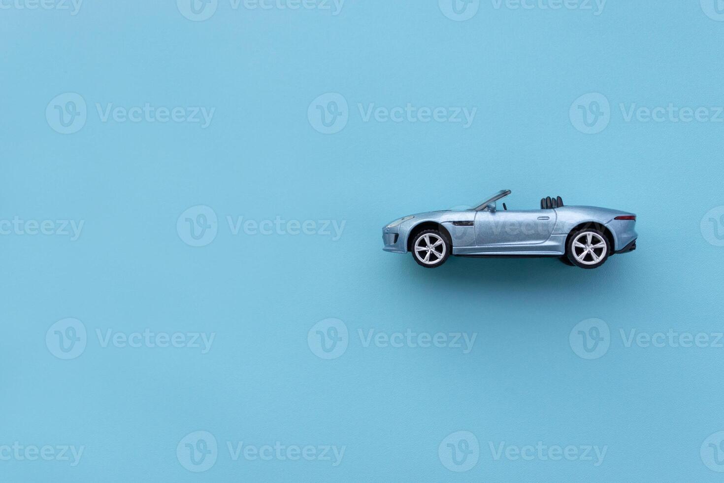 Blue toy car isolated on blue background. After some edits. photo