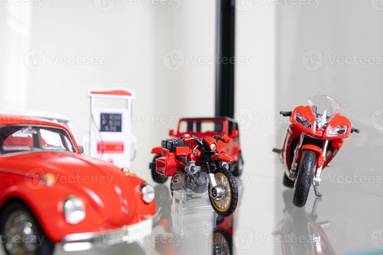 Selective focus. Red toys placed on glass shelf. After some edits. photo