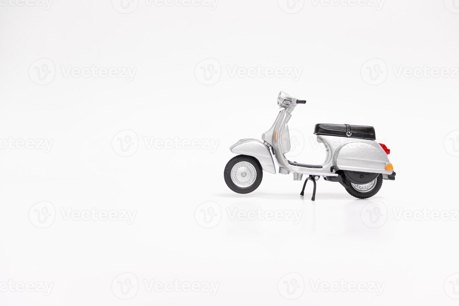 Miniature classic scooter on white background. After some edits. photo