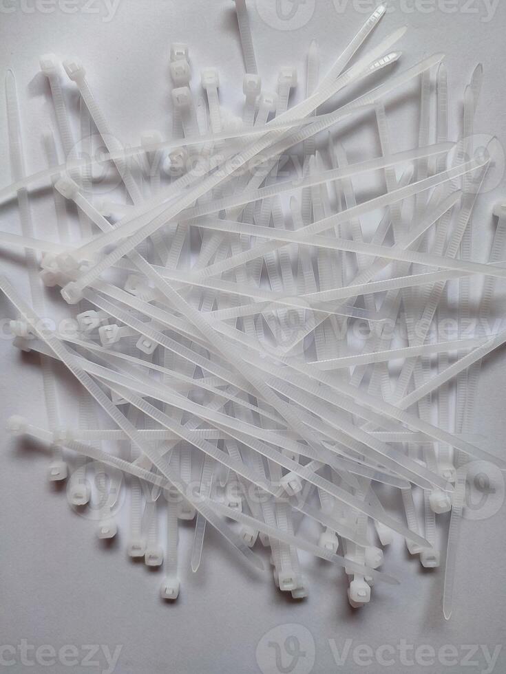 White plastic cable ties isolated on a white background photo