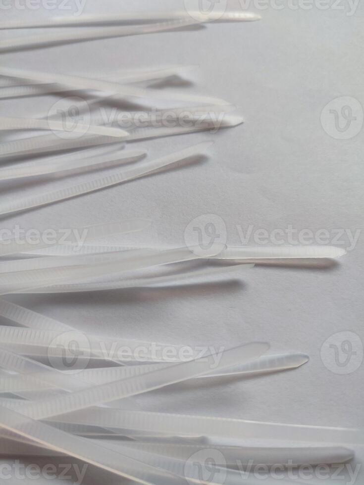 White plastic cable ties isolated on a white background photo