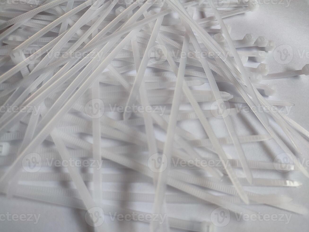 White plastic cable ties isolated on a white background photo