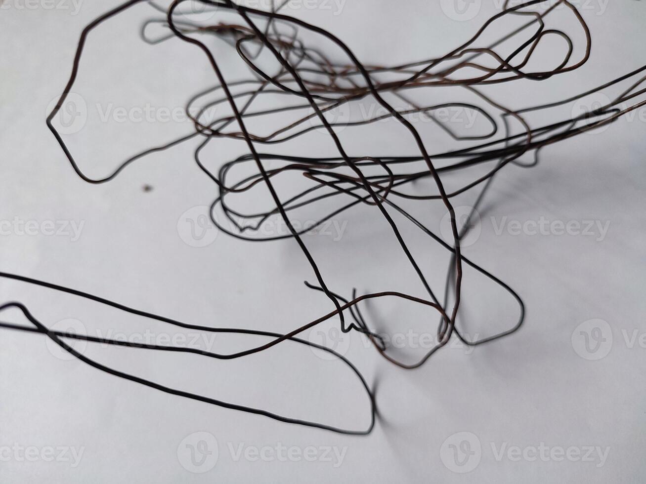 tangled black wire isolated on white photo