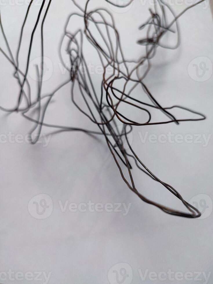 tangled black wire isolated on white photo