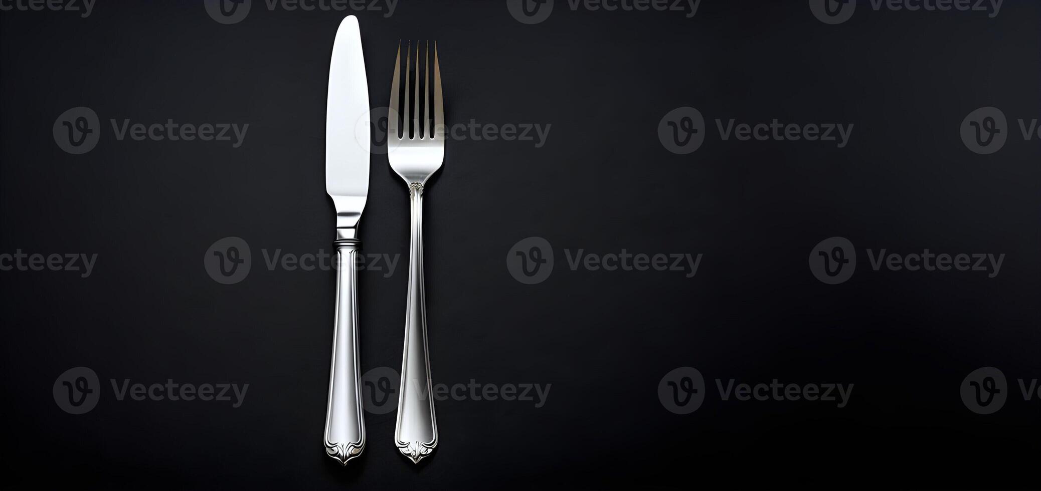 AI generated Fork and knife are presented on a dark background from top view representing cutlery photo