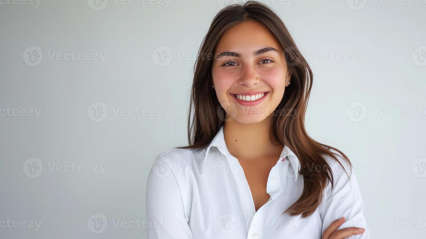 AI generated Cheerful brunette business woman student in white button up shirt, smiling confident and cheerful with arms folded, isolated on a white background photo