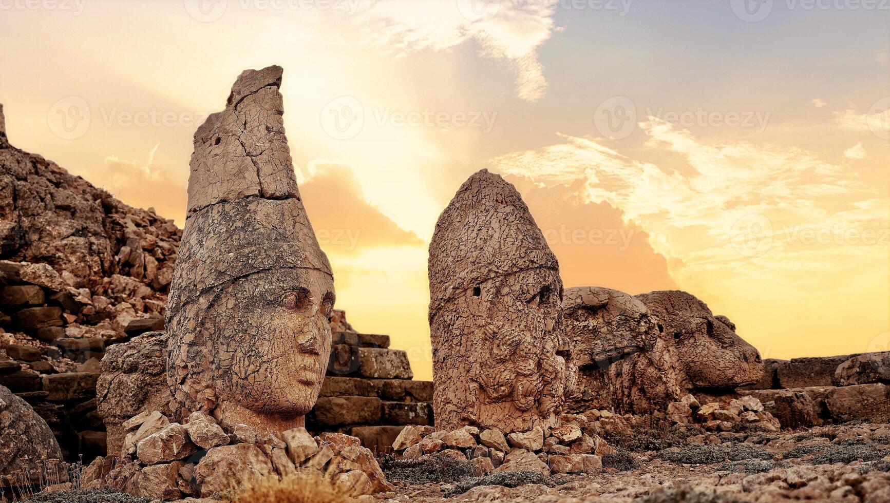 Antique ruined statues at sunrise on Nemrut mountain in Turkey. ancient Kingdom of Commagene in south east Turkey photo