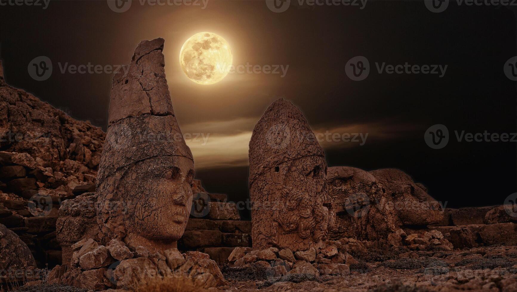 Antique ruined statues at sunrise on Nemrut mountain in Turkey. ancient Kingdom of Commagene in south east Turkey photo