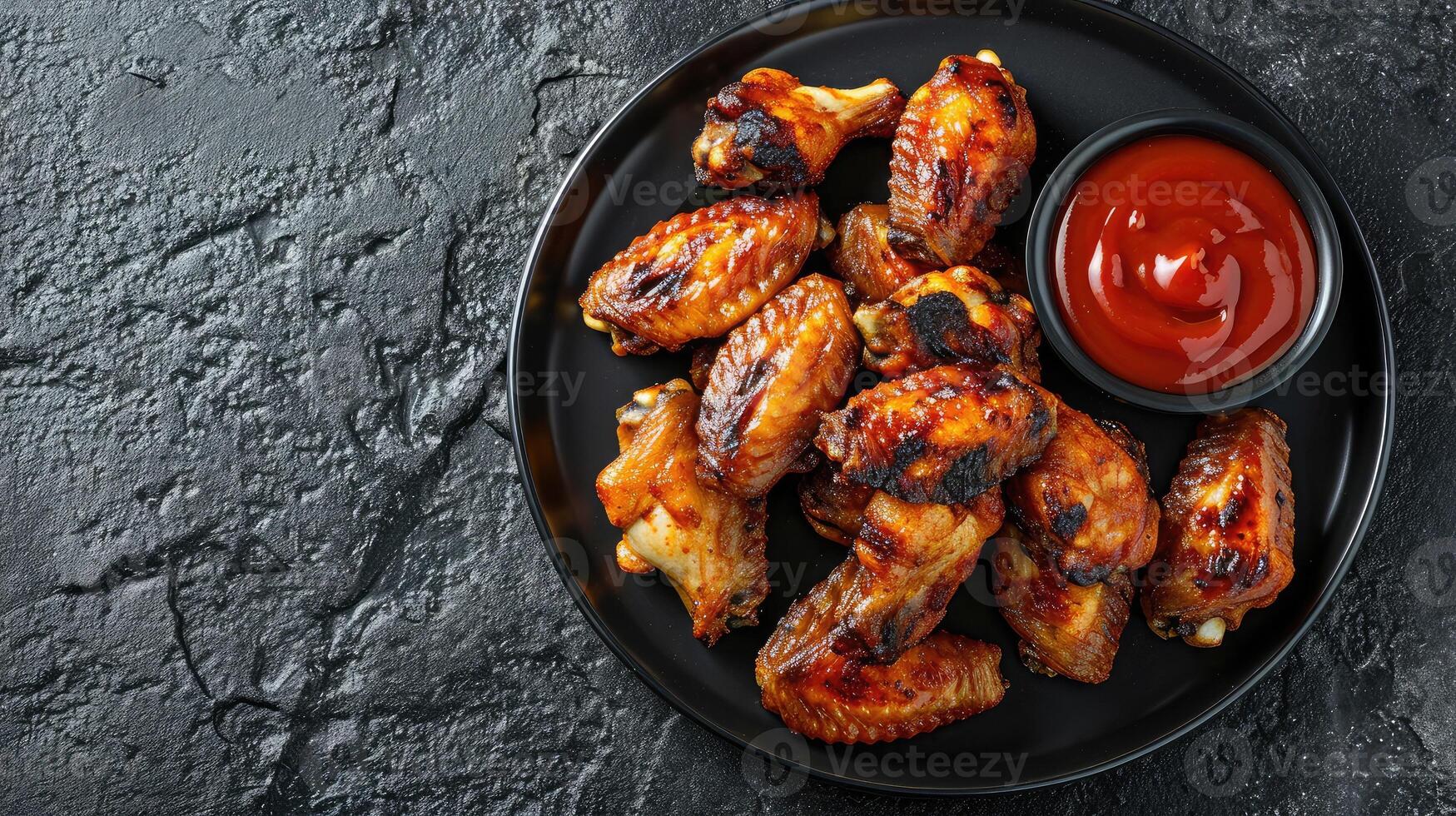 AI generated Grilled spicy chicken wings with ketchup on a black plate on a dark slate, stone or concrete background. Top view with copy space. photo