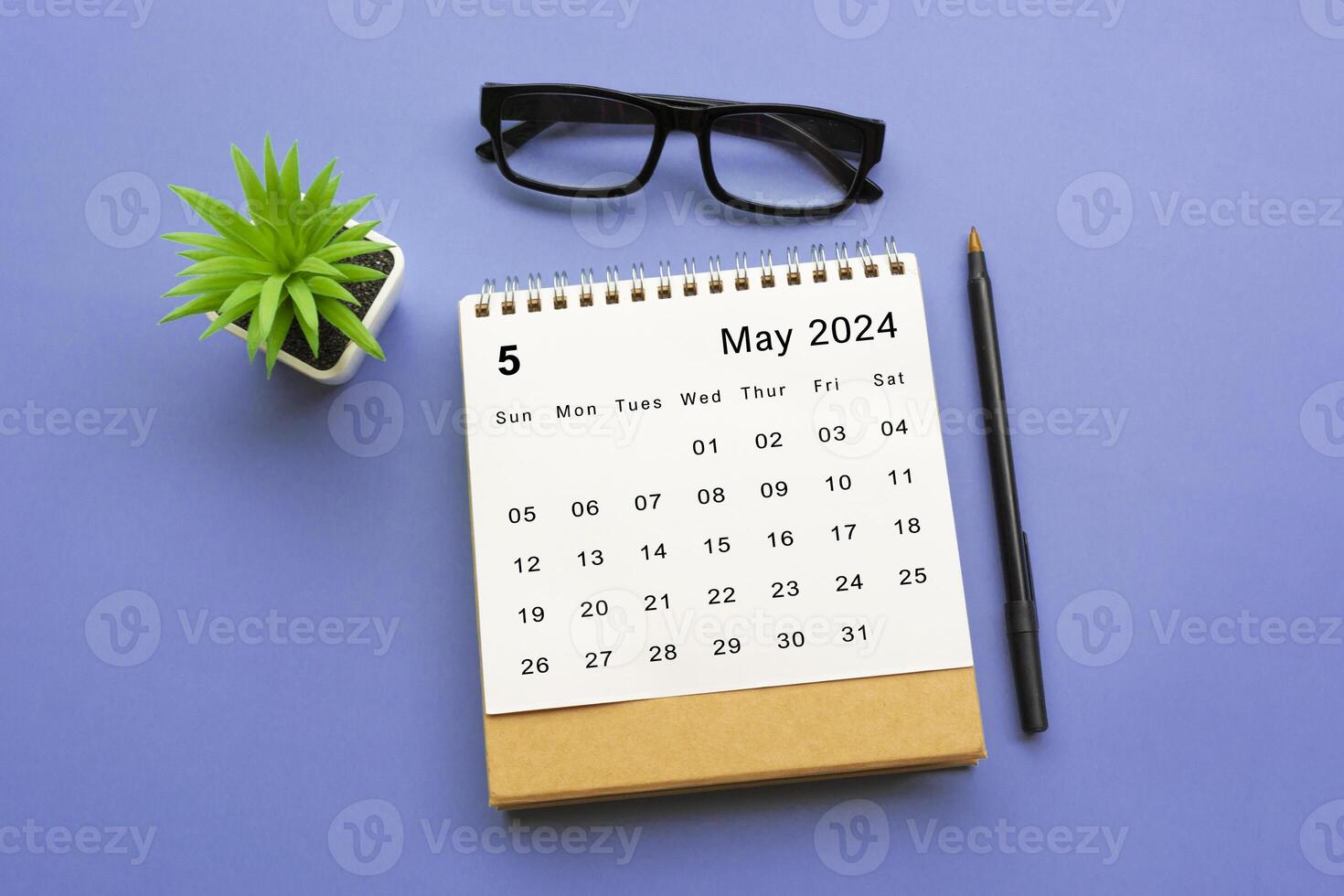 May 2024 desk calendar on blue background. photo