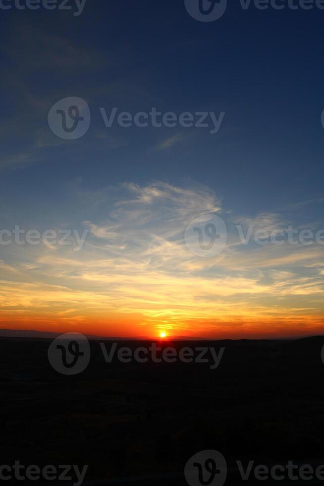Cumulus clouds and different color tones in the sky at sunset. Amazing and incredible sunset. photo