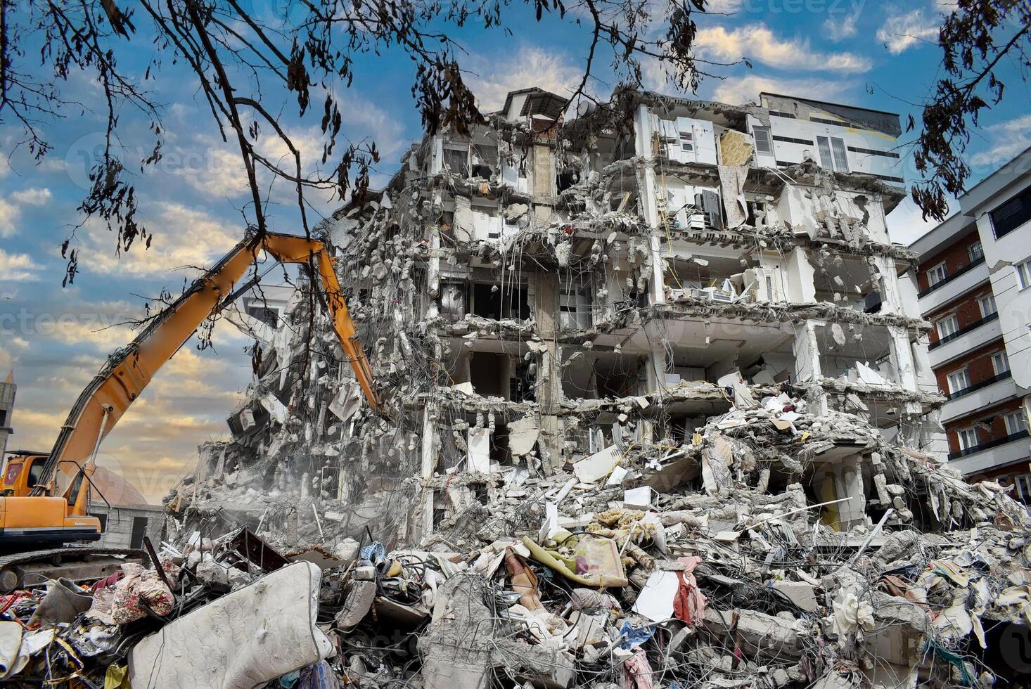 Buildings collapsed after the earthquake. Vehicles working after the earthquake. photo