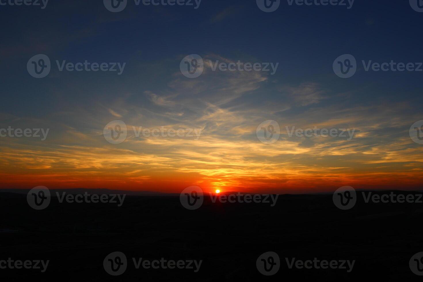 Cumulus clouds and different color tones in the sky at sunset. Amazing and incredible sunset. photo