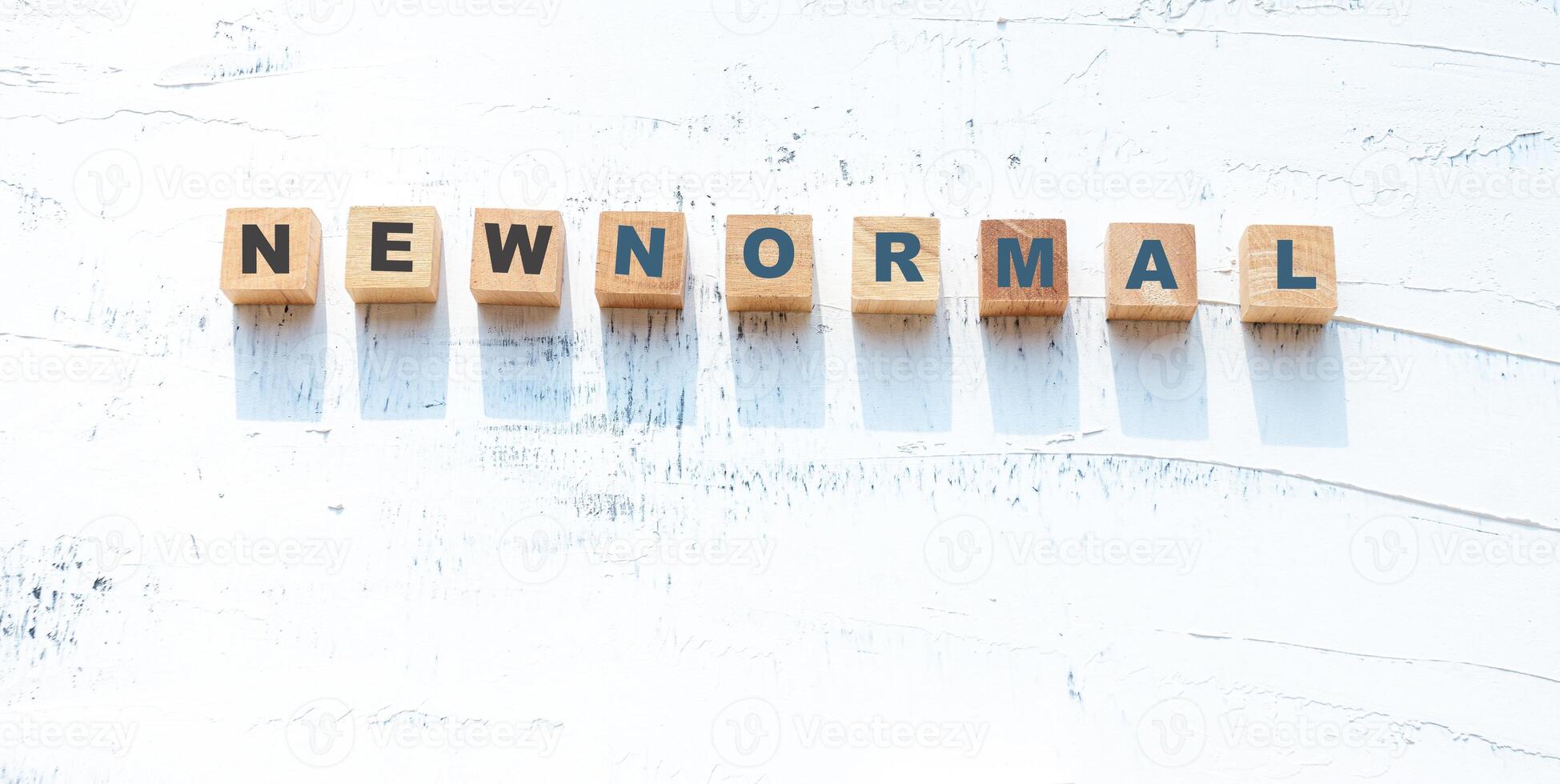 NEW NORMAL text on wooden block, A new world after the outbreak of COVID-19 photo