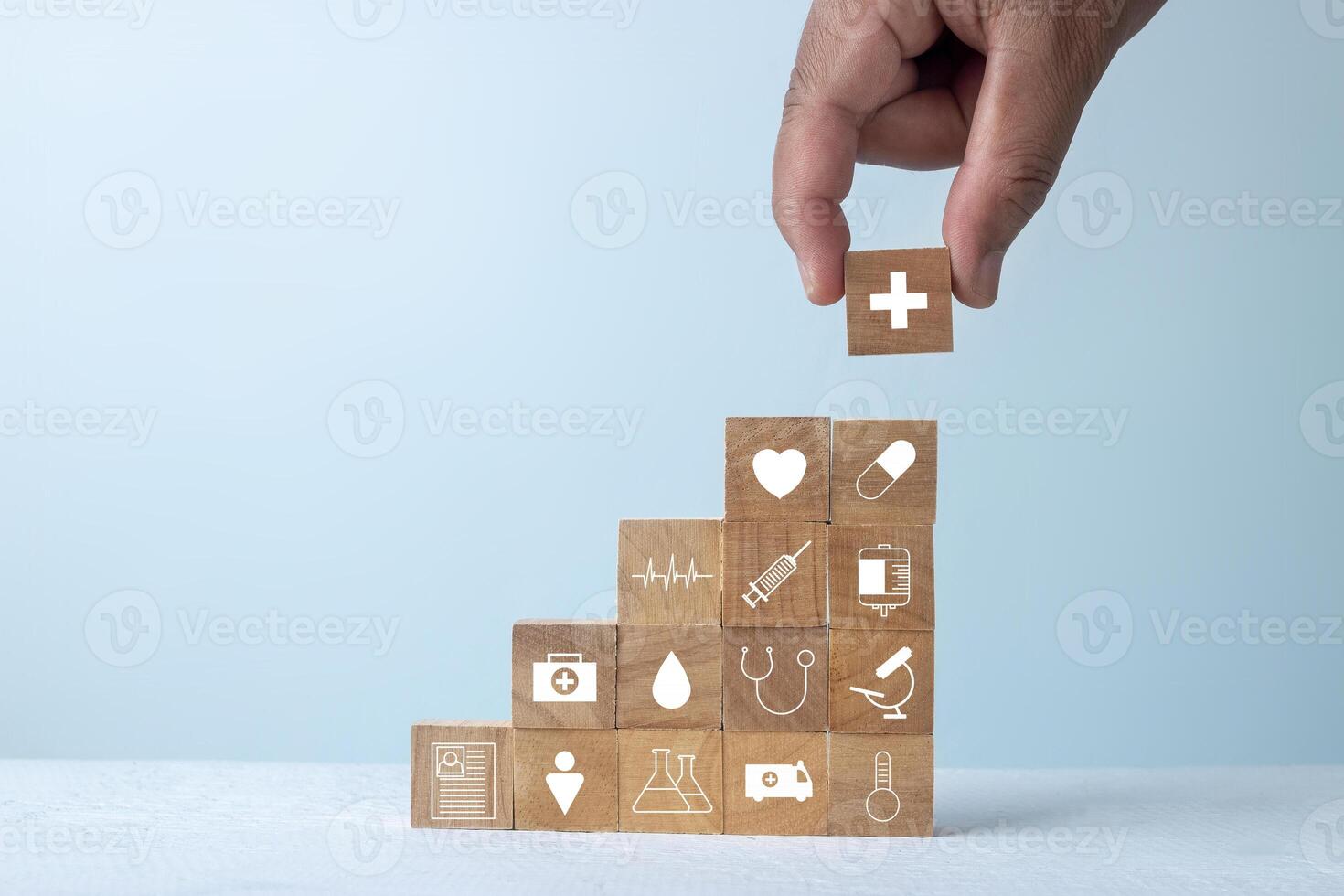 Insurance for your health and healthcare concept, Businessman hand arranging wood block stacking with icon healthcare medical. photo