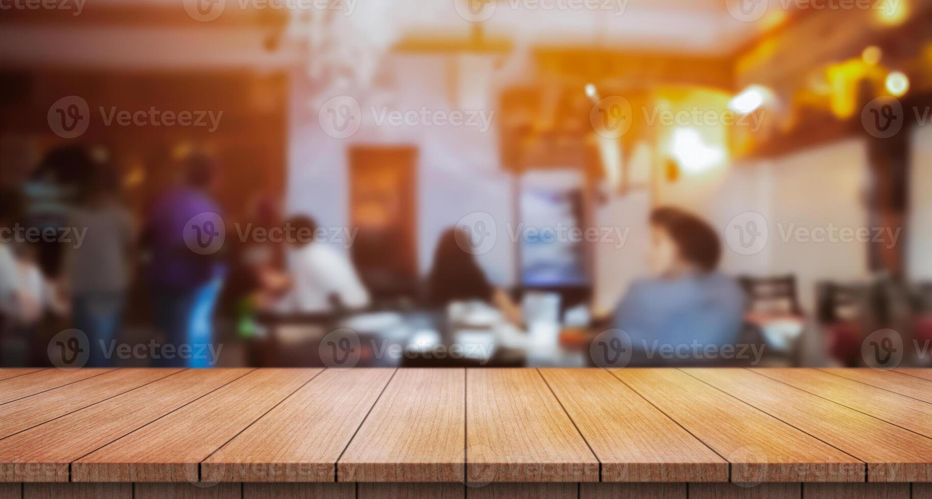 Empty wooden table top with lights bokeh on blur restaurant background. photo