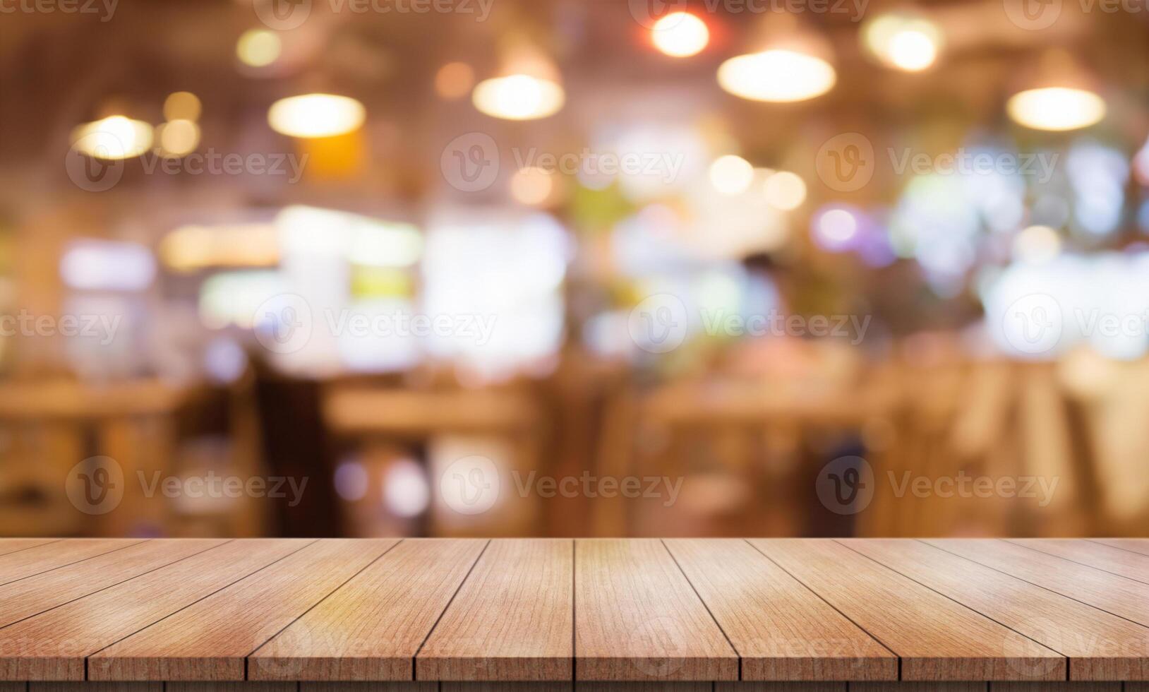 Empty wooden table top with lights bokeh on blur restaurant background. photo