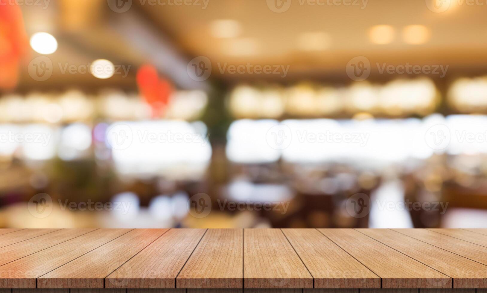 Empty wooden table top with lights bokeh on blur restaurant background. photo