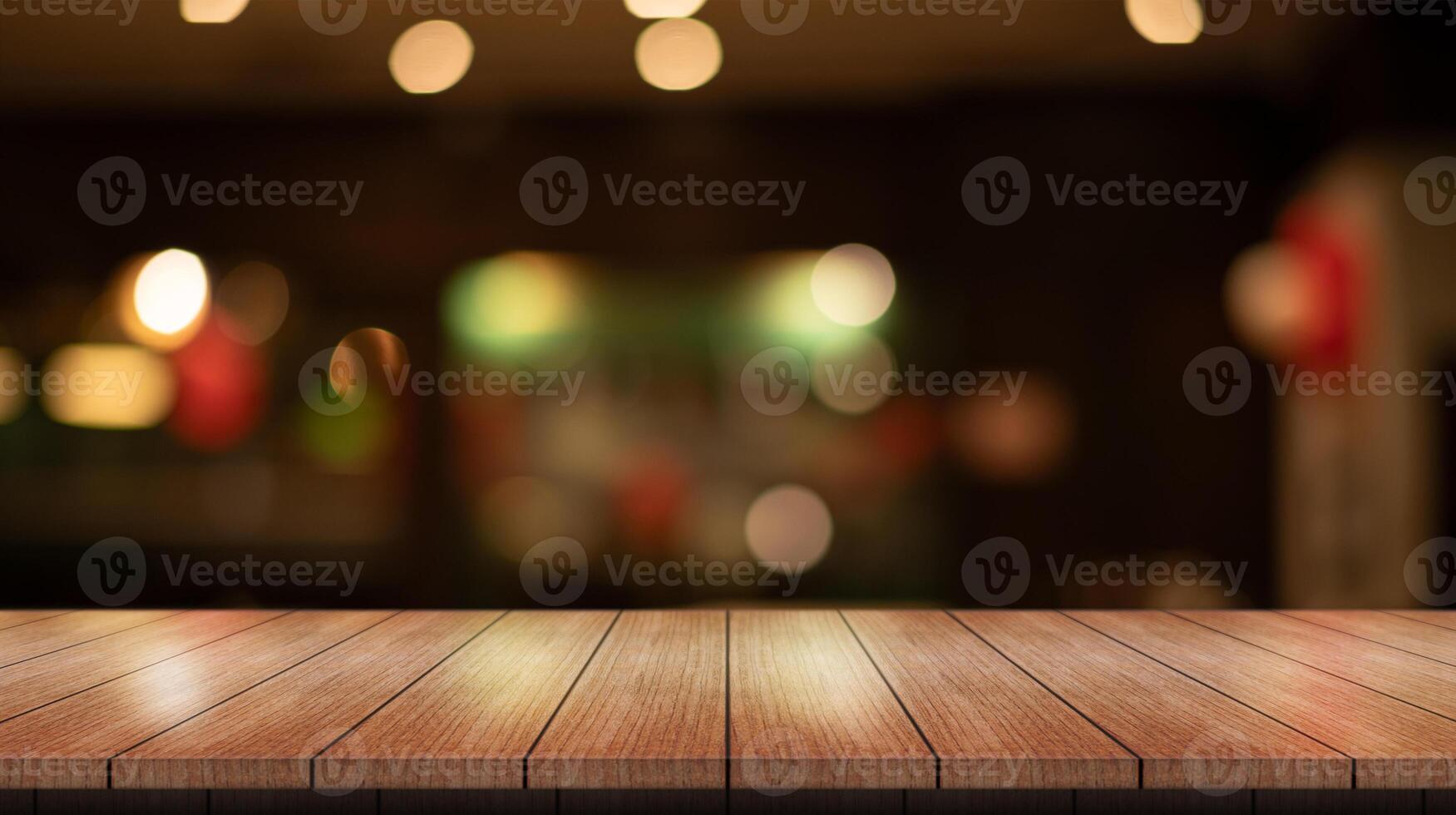 Empty wooden table top with lights bokeh on blur restaurant background. photo