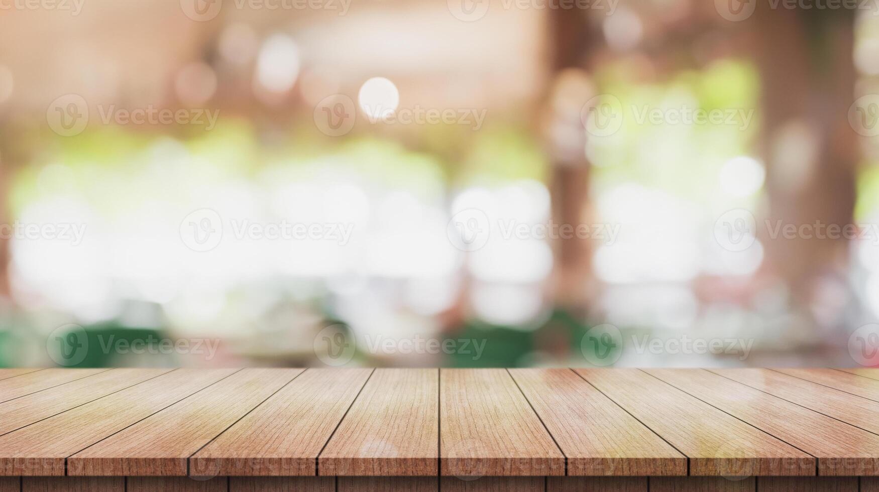 Empty wooden table top with lights bokeh on blur restaurant background. photo