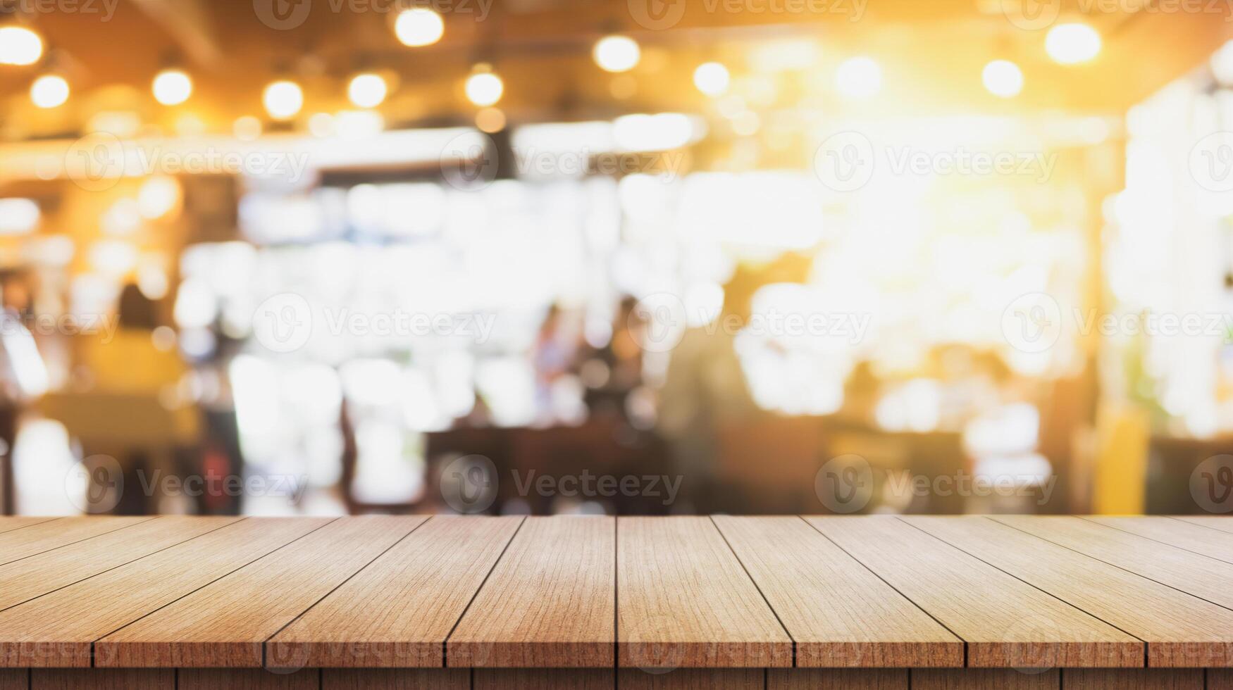 Empty wooden table top with lights bokeh on blur restaurant background. photo