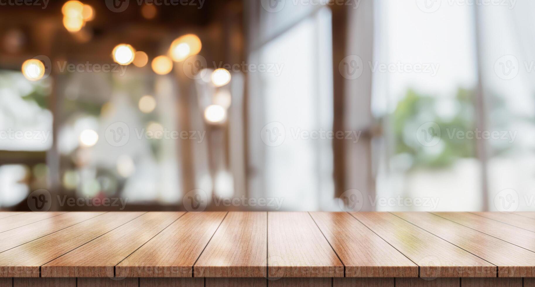 Empty wooden table top with lights bokeh on blur restaurant background. photo