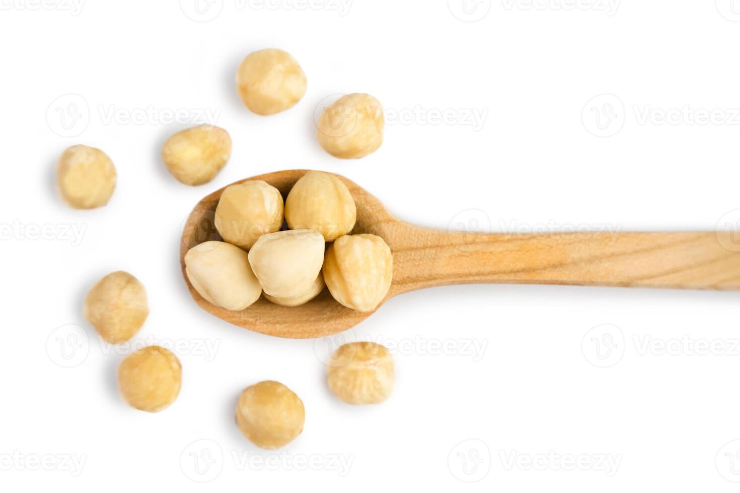 Dried hazelnuts in wooden spoon isolated on white background. Top view. Close-up. Banner. Selective focus. photo
