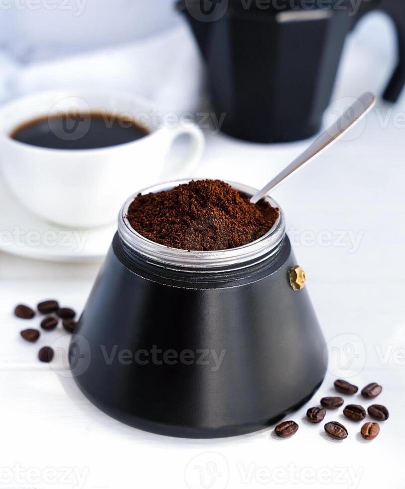 Natural freshly ground aromatic coffee in a geyser coffee maker for breakfast. World Coffee Day. Close-up. Selective focus. photo