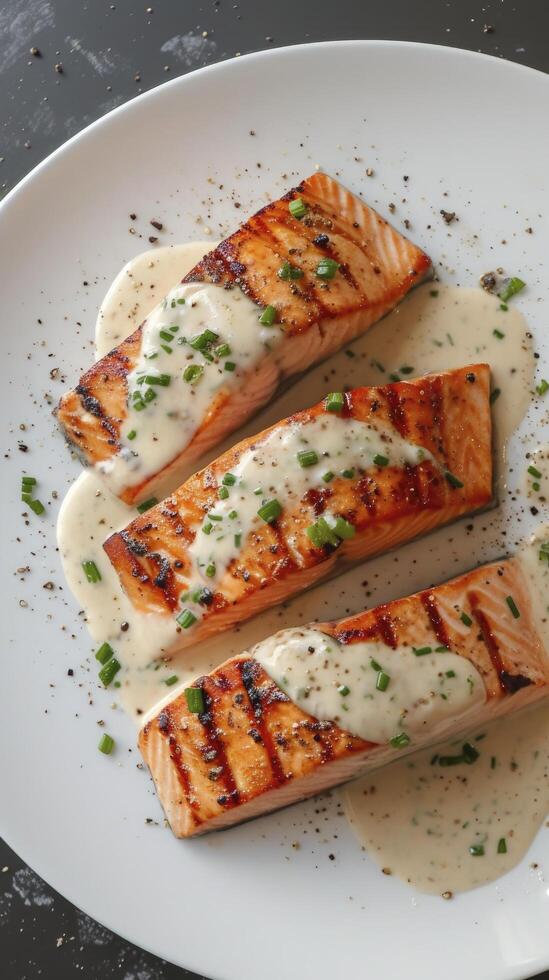 AI generated Slices of Grilled Salmon Drizzled with Creamy Mustard Chive Sauce, Artfully Presented on a White Plate photo