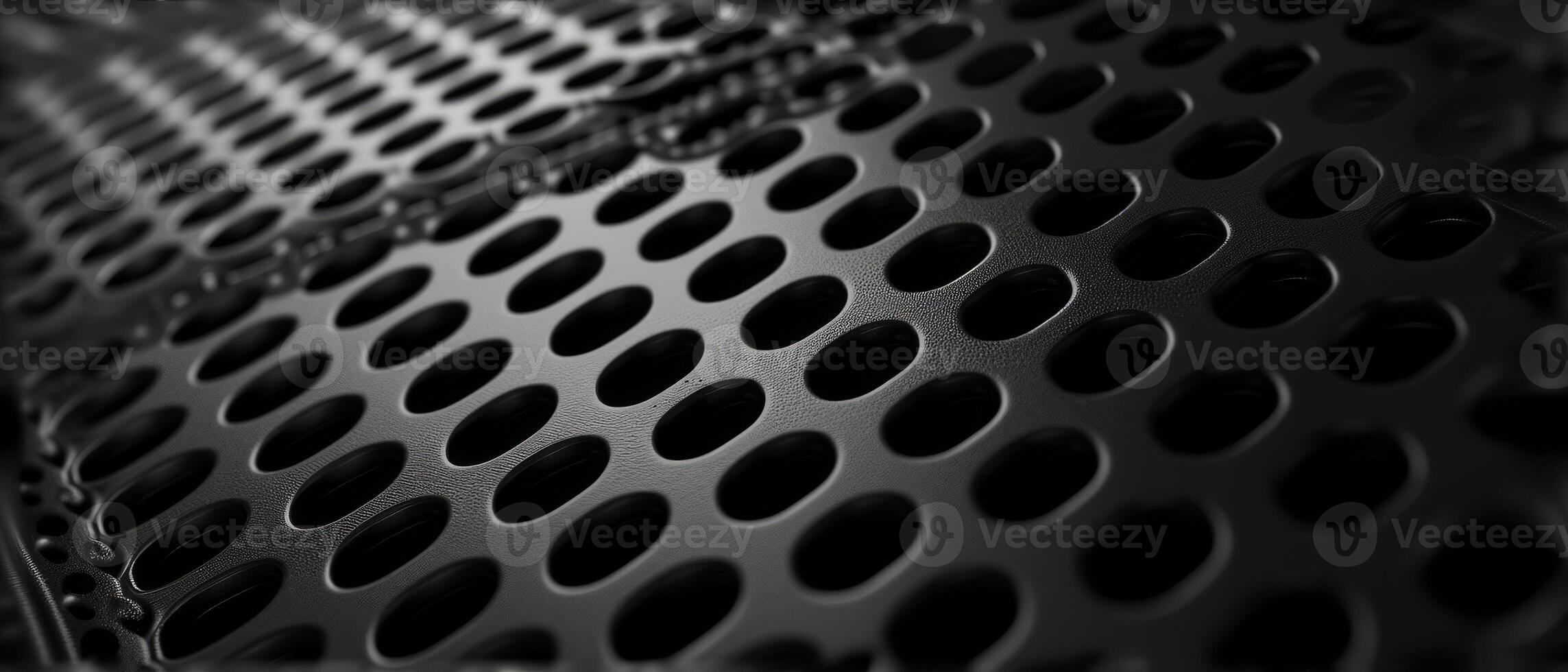 AI generated Macro shot of a black perforated metal surface with circular patterns photo